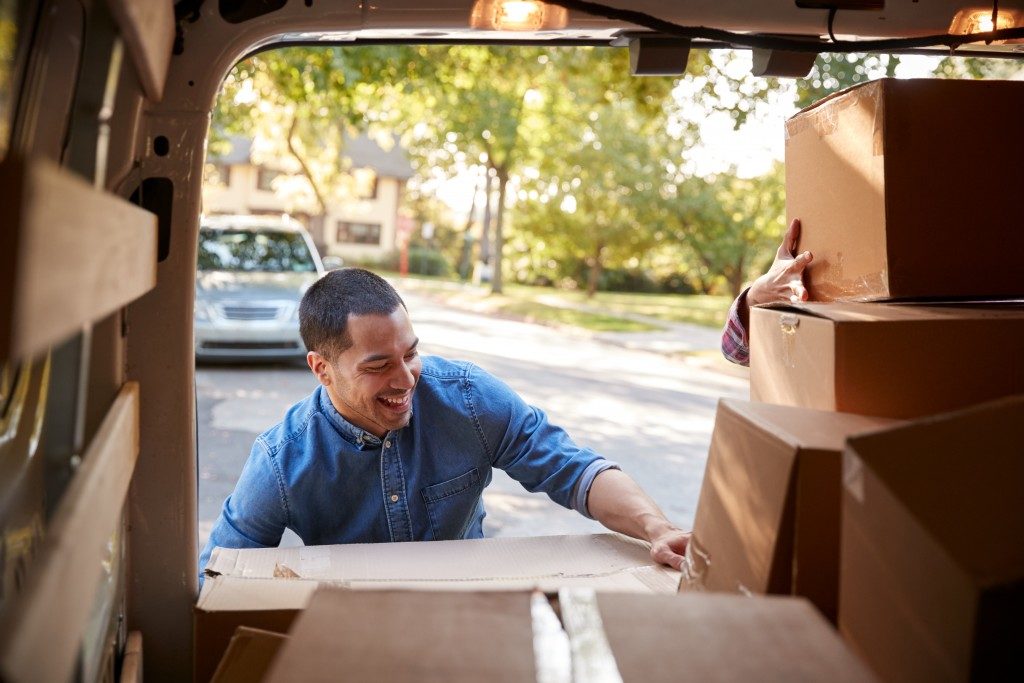 Man bringing out boxes from moving van