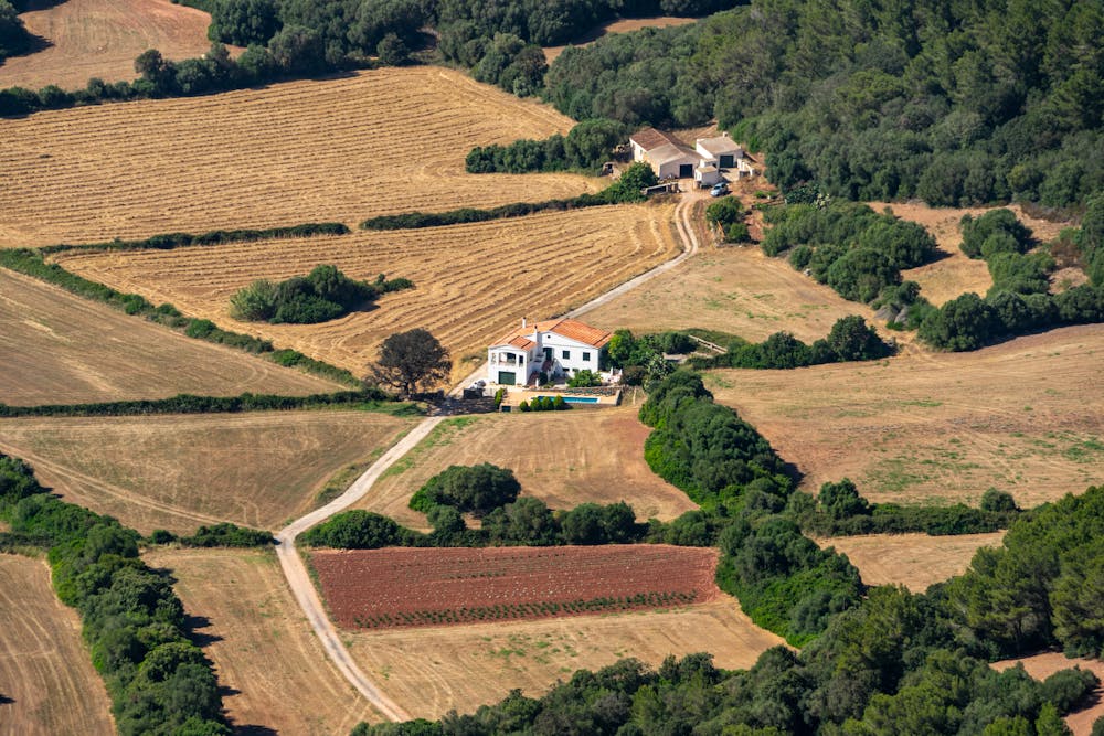 a rural house in the middle of a field