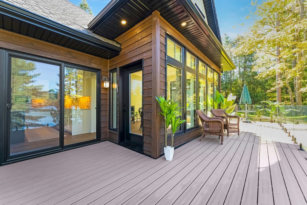 wooden deck featuring large windows and sliding doors